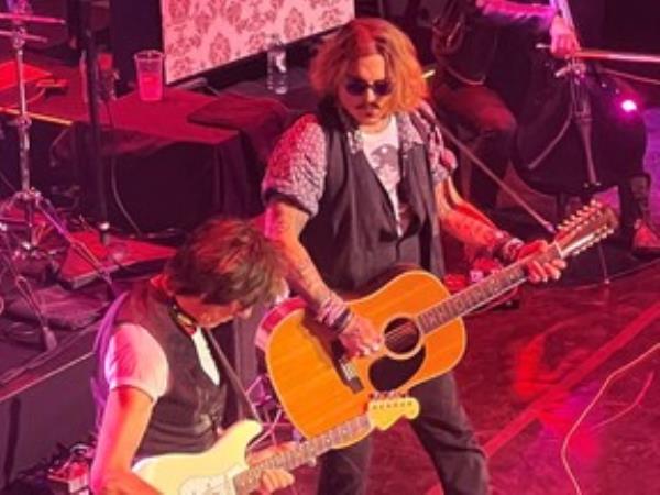 Actor Johnny Depp joins musician Jeff Beck on stage during a concert, in Gateshead, Britain June 2, 2022.