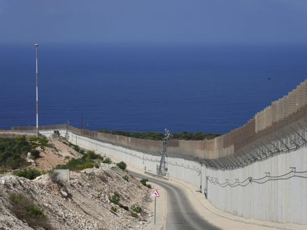 The wall on the Israeli border with Lebanon, is seen at right, with the Mediterranean Sea in the distance, in Ras Hanikra, Israel. The Associated Press