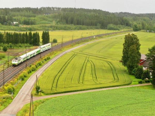 VR’s long-distance train rolling through a rural landscape in Janakkala, Southern Finland, in July 2020.