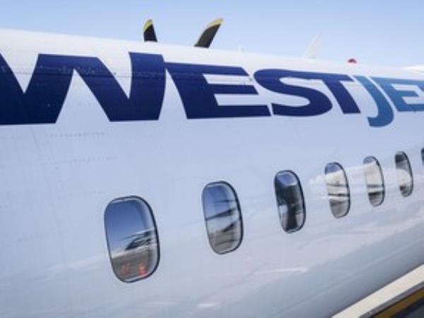 A WestJet plane waits at a gate at Calgary Internatio<em></em>nal Airport in Calgary.
